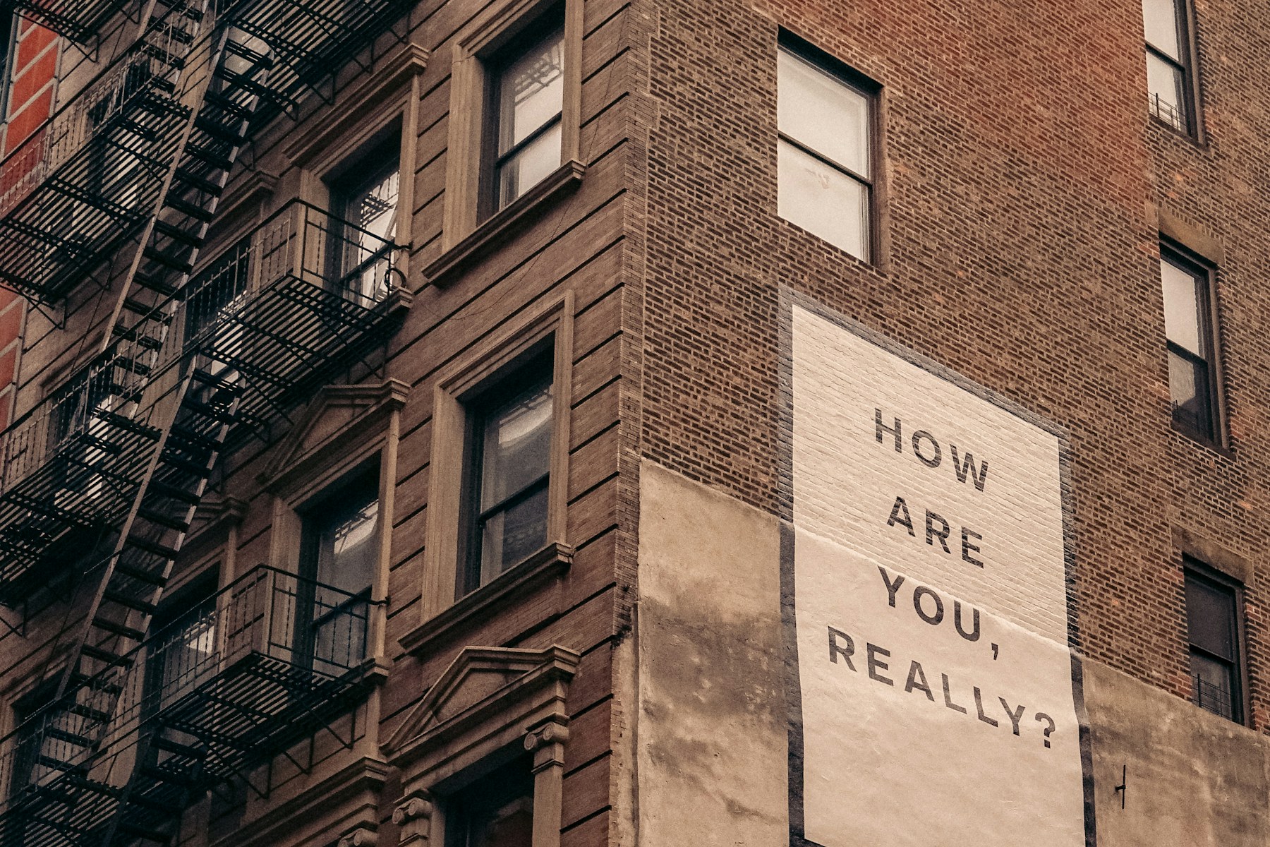 A building mural asking How are you, really?